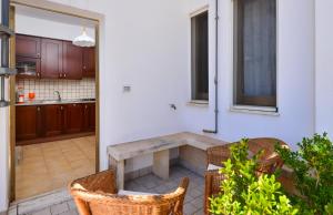 a kitchen with a table and chairs in a room at Balcone su Otranto in Otranto