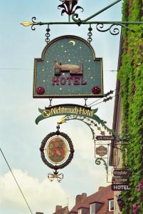 a sign for a hotel hanging from a building at Hotel Till Eulenspiegel - Nichtrauchhotel - in Würzburg