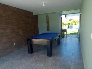 a ping pong table in the hallway of a house at Casa para temporada Florianópolis in Florianópolis
