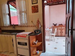 a kitchen with a sink and a stove top oven at Hospedaria Cobras E Lagartos in Angra dos Reis