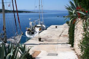 a boat is docked at a dock in the water at Apartments by the sea Cove Pokrivenik, Hvar - 4604 in Gdinj