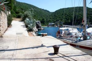 a boat is docked at a dock in the water at Apartments by the sea Cove Pokrivenik, Hvar - 4604 in Gdinj