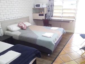 Postel nebo postele na pokoji v ubytování Paradise Motel