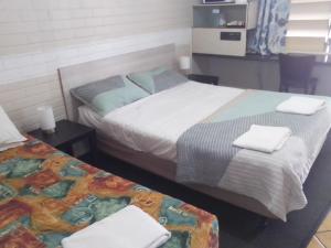 Postel nebo postele na pokoji v ubytování Paradise Motel