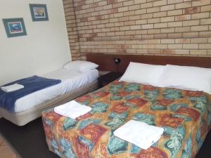 Postel nebo postele na pokoji v ubytování Paradise Motel