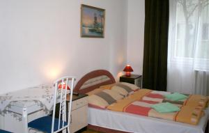 a small bedroom with a bed and a desk at Apartment4you Budapest in Budapest