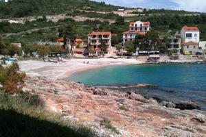 a beach with a group of houses on a hill at Seaside holiday house Milna, Hvar - 114 in Hvar
