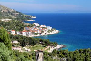 a town on a hill next to the ocean at Seaside holiday house Milna, Hvar - 114 in Hvar