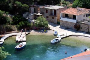 a group of boats are docked in the water at Apartments by the sea Basina, Hvar - 116 in Vrboska