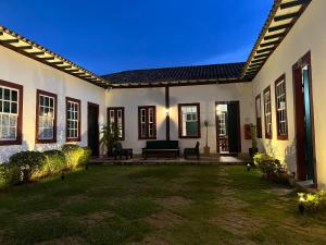 une maison avec une terrasse et une cour dans l'établissement Pousada Travessia - Minas Gerais, à Três Pontas