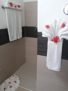 a bathroom with a white towel with red flowers on it at Vista Mare Samana The Best View!! in Santa Bárbara de Samaná