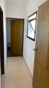 an empty hallway with a door and a window at Altos San Martín in Concepción del Uruguay