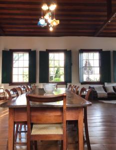 a dining room with a wooden table and chairs at Pousada Travessia - Minas Gerais in Três Pontas