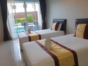 Postel nebo postele na pokoji v ubytování Retreat Resort Pattaya