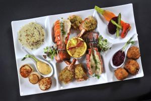 a white plate with different types of food on it at Hotel Forestel in Val-dʼOr