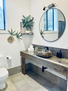 a bathroom with a sink and a mirror at Coastal bush gateway nr South West Rock Beach in Arakoon