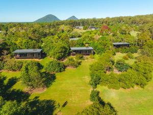 an aerial view of a house with a yard at Glass On Glasshouse in Glass House Mountains