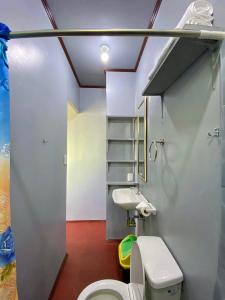 a bathroom with a toilet and a sink at Selim Guesthouse in San Vicente