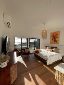 a bedroom with a bed and a table and chairs at Sea Dragon Kangaroo Island in Penneshaw