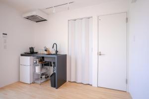a white room with a refrigerator and a door at Trailer room - Vacation STAY 06457v in Makinohara