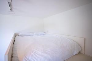 a white bed with two pillows on top of it at Trailer room - Vacation STAY 06457v in Makinohara