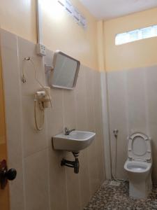 a bathroom with a sink and a toilet at Pina House in Kep