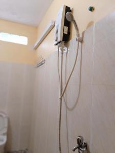 a shower in the corner of a bathroom at Pina House in Kep