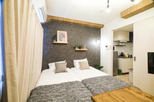 a bedroom with a large bed in a room at La Lumiere Oroku in Akamine