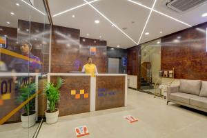 a man standing at a counter in an office at MySpace Tattwa Grand in Yelahanka