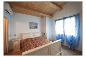 a bedroom with a large bed and a window at Bed & Breakfast Montesterlino in Cesena