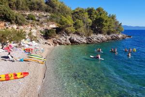 a group of people in the water at a beach at Seaside secluded apartments Cove Jedra, Hvar - 2583 in Gdinj