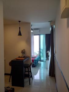 a room with a desk and a table and a window at Sunset View 969 PD Waterfront in Port Dickson