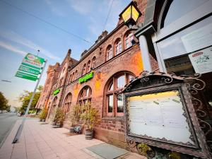 a sign in front of a brick building at Hotel Hoepfner Burghof in Karlsruhe