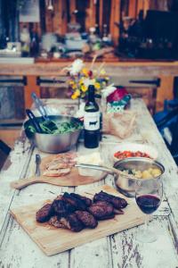 a table with some food and a glass of wine at The Paddock Wildcamp in Perranporth