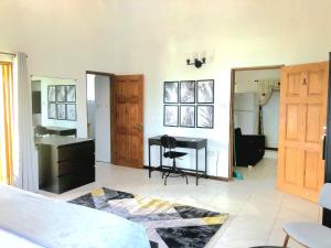 a bedroom with a desk and a sink at Bay View Apartment 4 - Canouan Island in Canouan