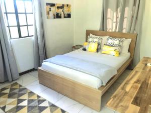 Ένα ή περισσότερα κρεβάτια σε δωμάτιο στο Bay View Apartment 4 - Canouan Island