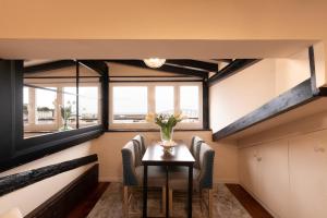a dining room with a table and chairs and a window at Itsasaurre - baskeyrentals in Ondárroa