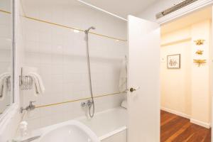 a white bathroom with a sink and a shower at Itsasaurre - baskeyrentals in Ondárroa +35 photos