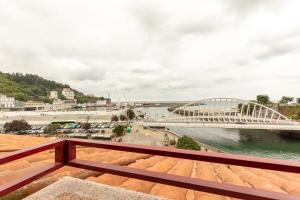 a view of a river and a bridge at Itsasaurre - baskeyrentals in Ondárroa