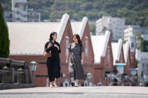 two women walking down a street in a city at fav HAKODATE in Hakodate