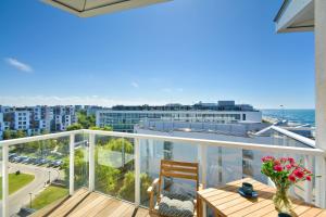 a balcony with a table and a view of the ocean at NORTH Apartments, SeaView Seaside Park in Kołobrzeg