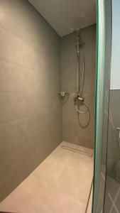 a bathroom with a shower with a glass door at SITARA HOTEL APARTMENT in Dubai