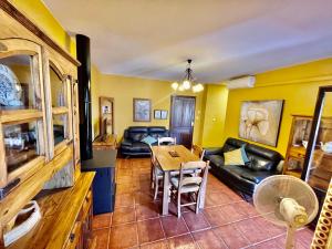 a living room with a couch and a table at Ático Casa Ángel in Bubión