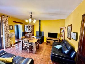 a living room with a couch and a table at Ático Casa Ángel in Bubión