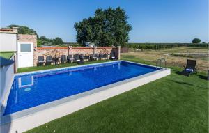 a swimming pool in the yard of a house at 5 Bedroom Lake Front Home In Ceminac in Čeminac