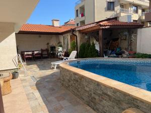 a swimming pool in the backyard of a house at Villa Diana in Sozopol