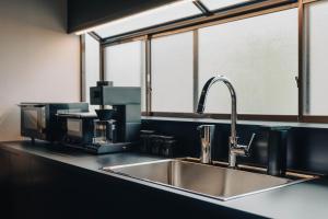 a kitchen counter with a sink and a window at 河内家 in Fujikawaguchiko