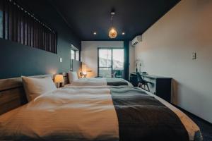 a bedroom with a large bed and a desk at 河内家 in Fujikawaguchiko