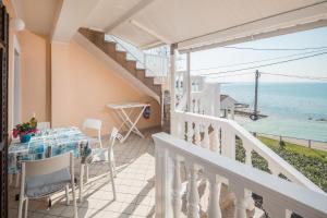 a balcony with a table and chairs and the ocean at Apartment Zambratija 2557a in Zambratija