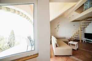 a living room with a large window and a staircase at Apartment Selce 5206a in Selce
